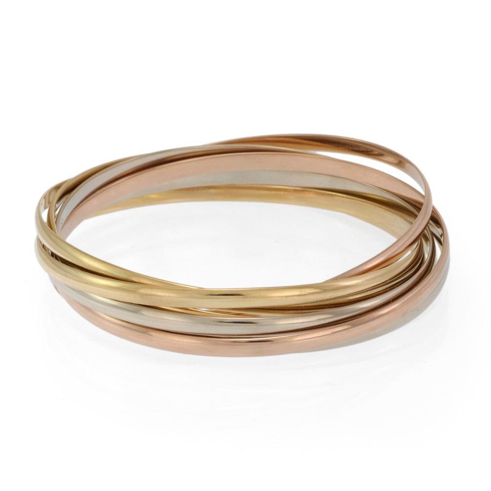 Cartier Trinity 18k Gold 7 Interlaced Bangles 3.5mm with Hallmark: Cartier Trinity 18k Gold 7 Interlaced Bangles 3.5mm with Hallmark This exquisite set of interlaced bangles by Cartier showcases the brand's iconic Trinity design, featuring three colors of gold: yello