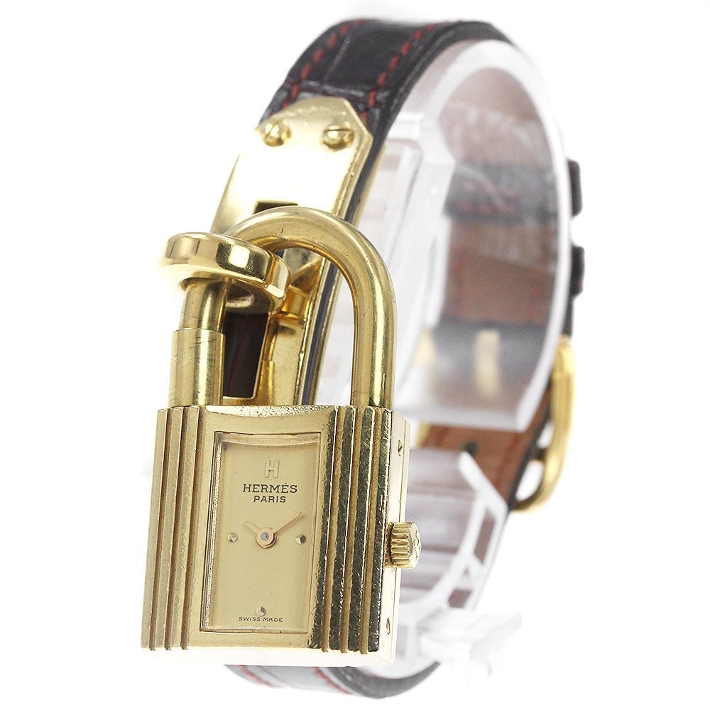 Hermes Kelly Watch Swiss Quartz Leather Band Women: Hermes Kelly Watch Swiss Quartz Leather Band Women This Hermes Kelly Quartz women's wristwatch features a stainless steel and gold-plated case with a gold-tone dial. The watch is powered by a quartz m
