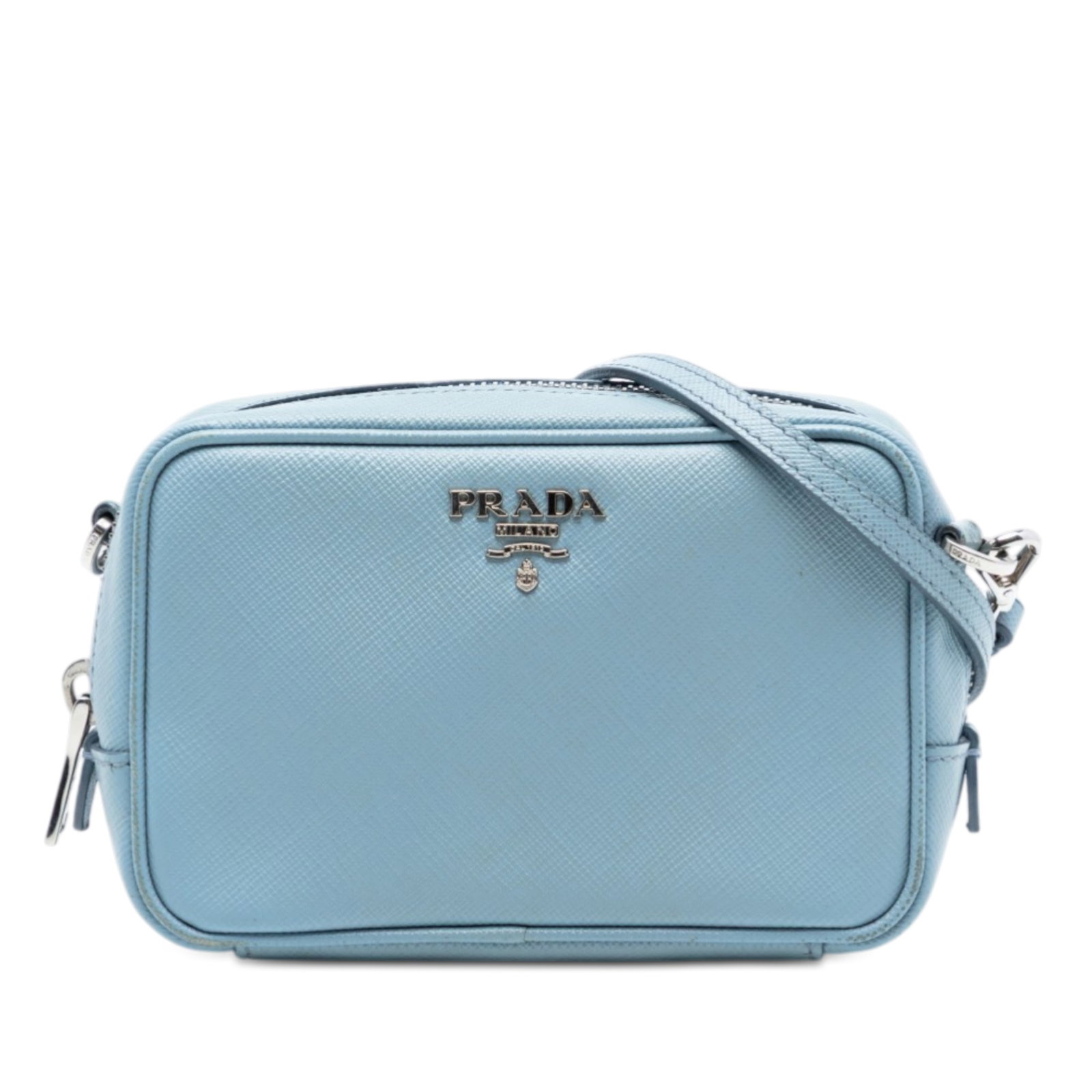 Prada blue saffiano leather crossbody camera bag: Prada blue saffiano leather crossbody camera bag This Prada Mini Saffiano Camera Bag is crafted from durable saffiano leather in blue and designed as a compact crossbody. It features an adjustable and