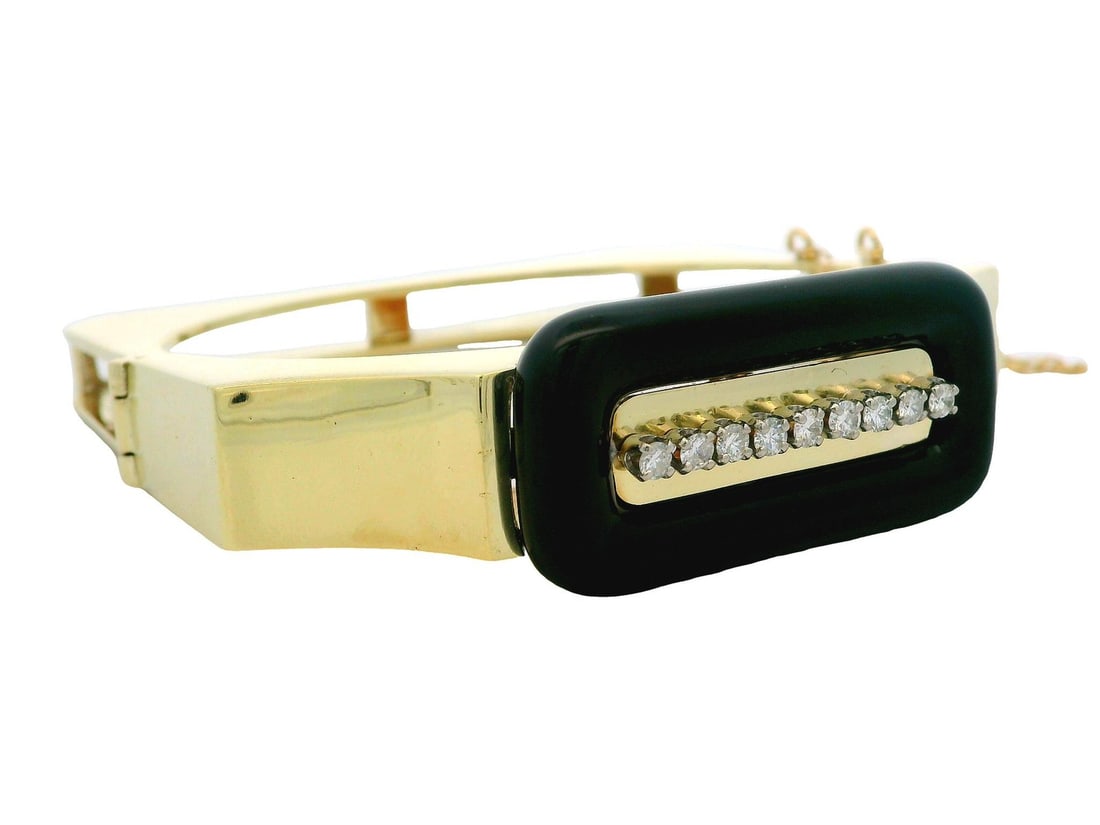 Vintage Retro 14K Gold Black Onyx Diamond Hinged Bangle: Vintage Retro 14K Gold Black Onyx Diamond Hinged Bangle This vintage retro hinged open bangle beautifully combines 14k yellow gold with a striking black onyx centerpiece and sparkling diamonds. The ba