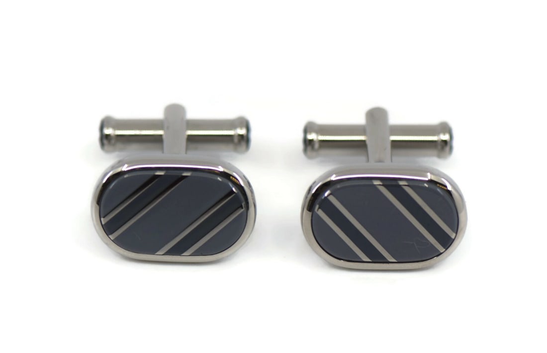 Montblanc Star cufflinks stainless steel with box: Montblanc Star cufflinks stainless steel with box These Montblanc Star cufflinks are crafted from stainless steel and feature an elegant oval shape with a striped design. Made in Italy, they come in t