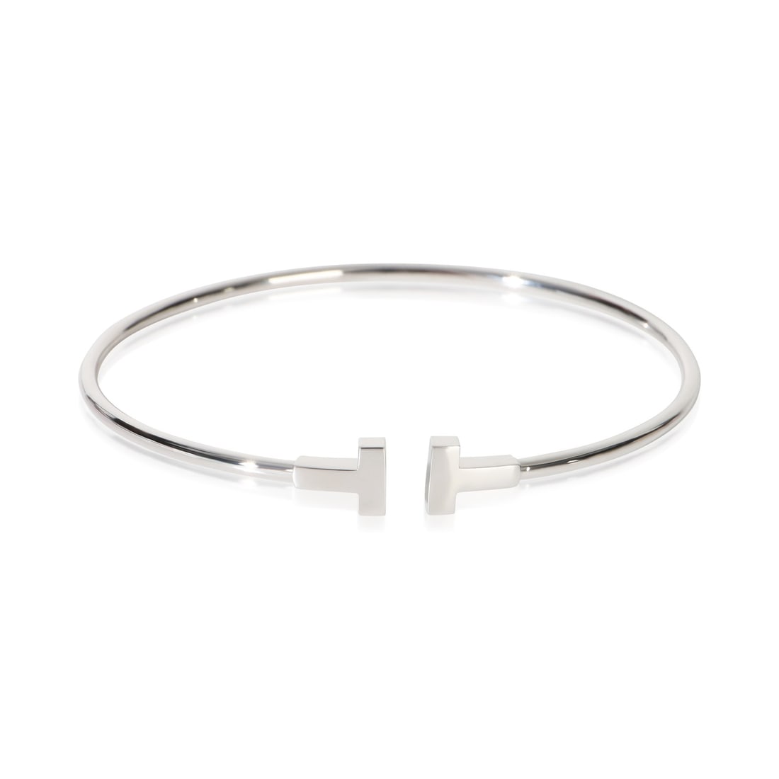 Tiffany T Narrow 18k White Gold Bracelet with Pouch: Tiffany T Narrow 18k White Gold Bracelet with Pouch This Tiffany & Co. Tiffany T Narrow Bracelet is crafted from 18k white gold and features a sleek, minimalist design. Designed for women, it is part 