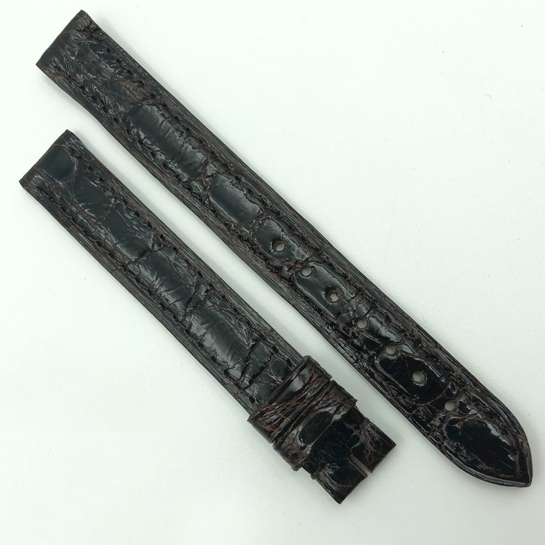 Cartier 12mm dark brown leather wristwatch band 5801A03OCCA: Cartier 12mm dark brown leather wristwatch band 5801A03OCCA This is an authentic Cartier 12mm dark brown leather wristwatch strap, model 5801A03OCCA. Designed for unisex adults, this two-piece strap f