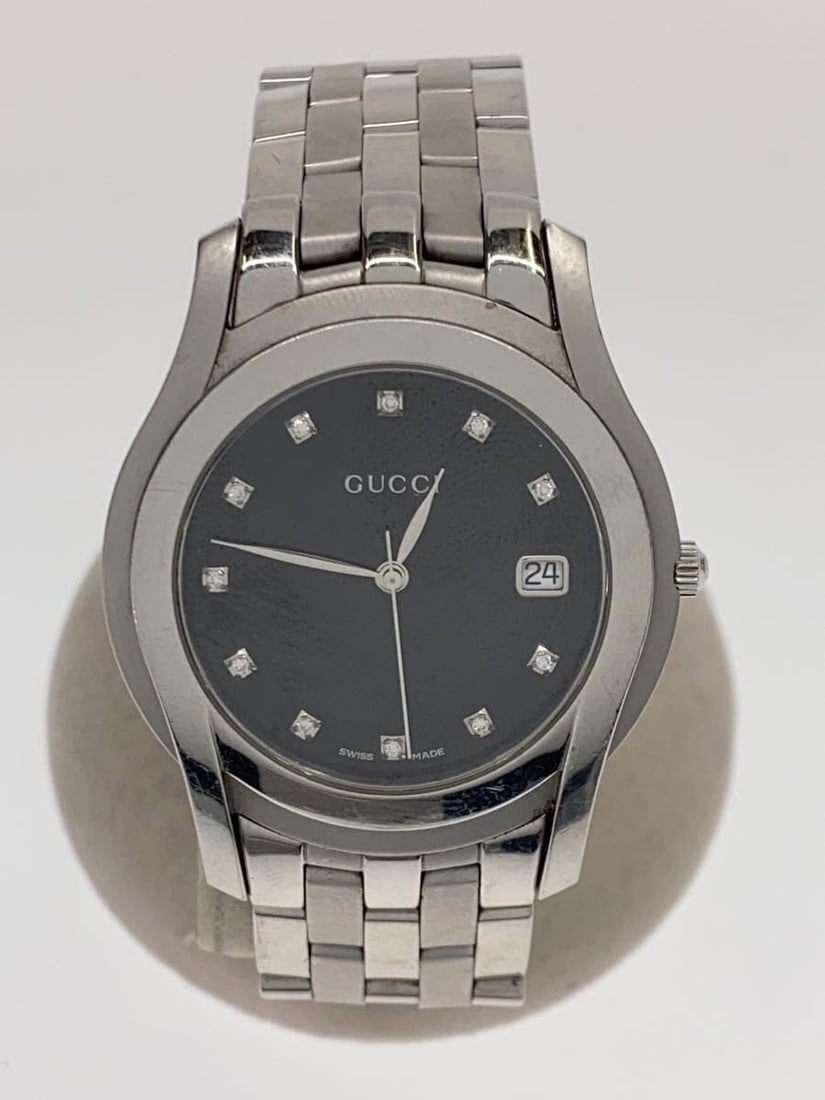 Gucci 5500M Quartz Stainless Steel Stone Set Wristwatch: Gucci 5500M Quartz Stainless Steel Stone Set Wristwatch This Gucci Quartz 5500M men's wristwatch features a black dial set in a stainless steel case. The watch is stone-set and designed for men, offer