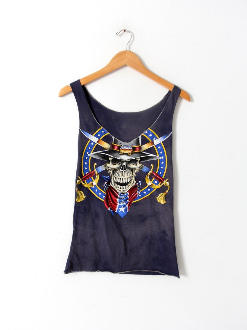 Black Skull and Swords Graphic Re-Cut Vintage Biker Tank XS: Black Skull and Swords Graphic Re-Cut Vintage Biker Tank XS This vintage re-cut black biker tank top features a bold skull with crossed swords graphic across the chest. Crafted from soft, worn-in fabr
