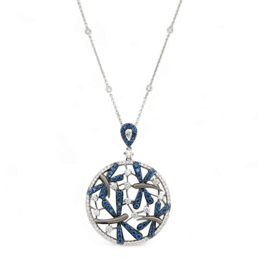Crivelli 18K White Gold Diamond Blue Sapphire Pendant Necklace 2.77ctw: Crivelli 18K White Gold Diamond Blue Sapphire Pendant Necklace 2.77ctw This exquisite Crivelli pendant necklace is a stunning piece crafted in 18K white gold, featuring an elegant circular design. It 