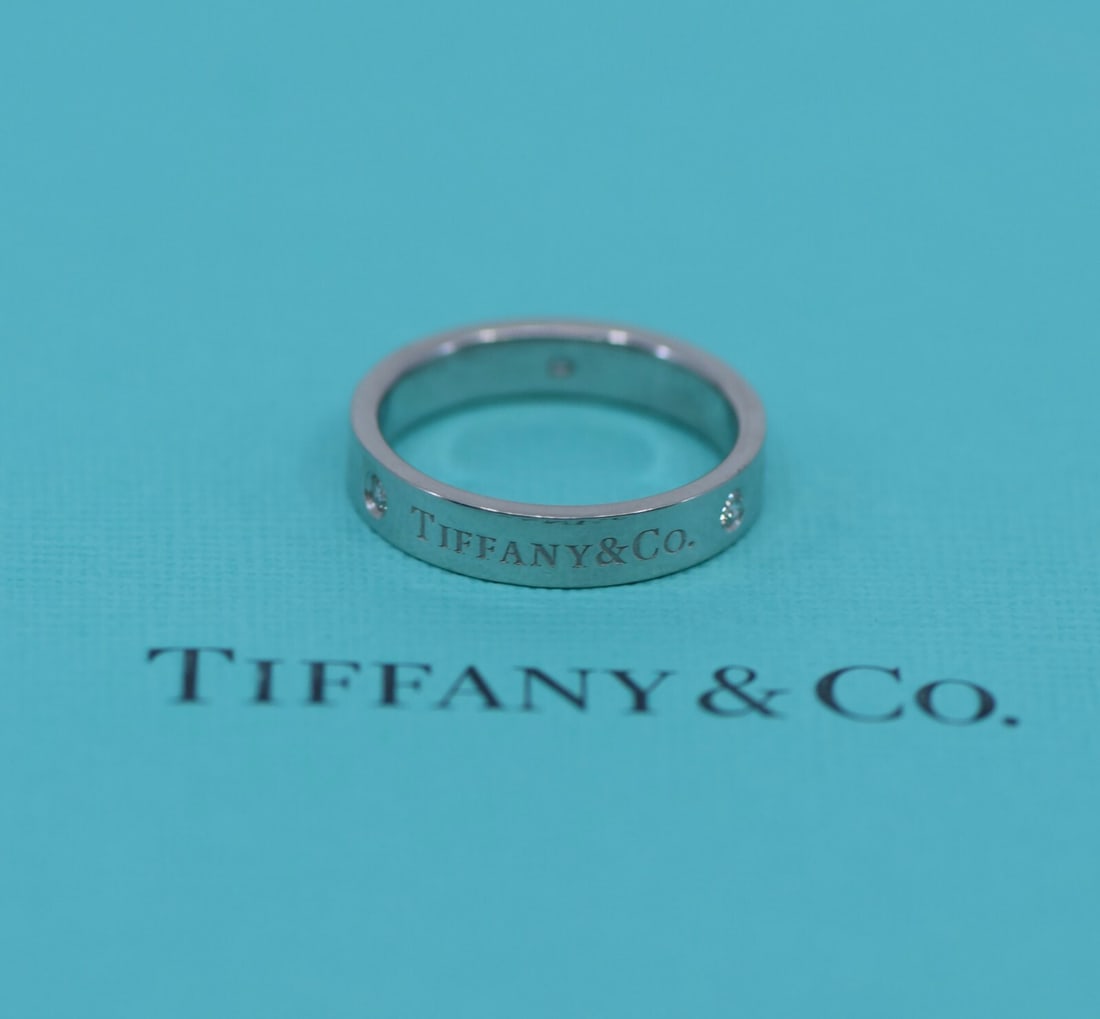 Tiffany & Co Diamond Ring Platinum 4mm Size 6.75 Authentic: Tiffany & Co Diamond Ring Platinum 4mm Size 6.75 Authentic Presenting a stunning Tiffany & Co. diamond ring crafted in high-quality platinum. This elegant ring features a main diamond centerpiece, sho