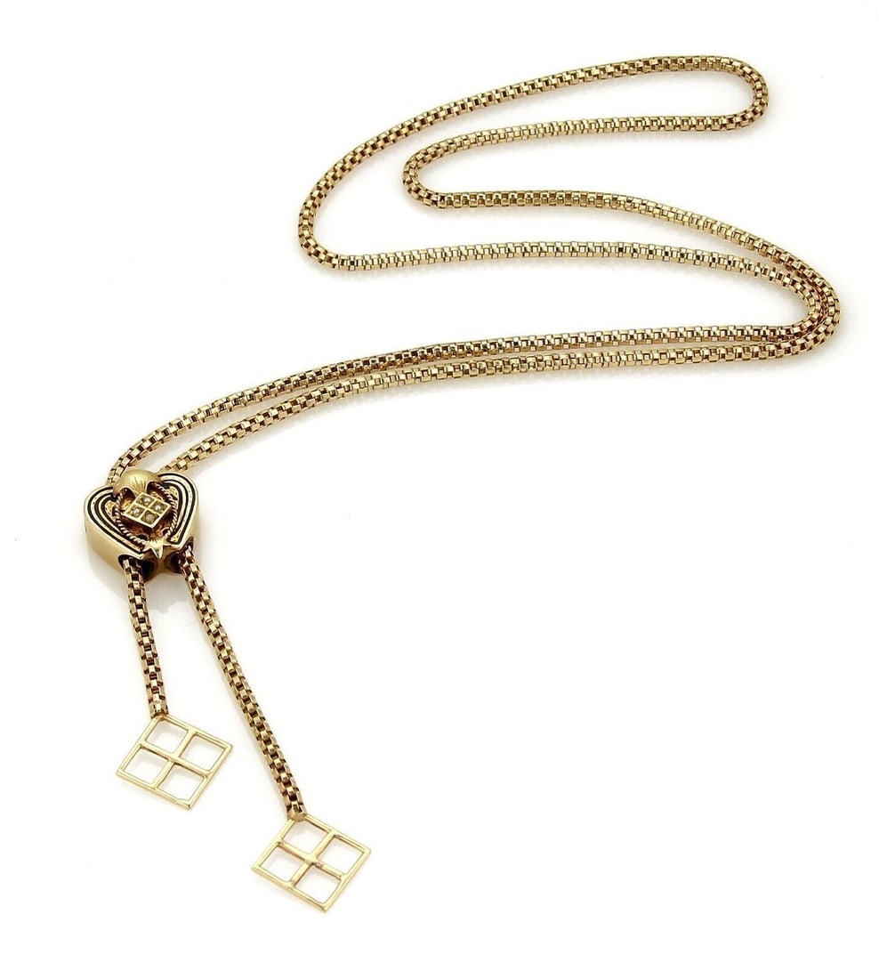 Vintage 14k Yellow Gold Heart Slide Lariat Necklace with Tassel: Vintage 14k Yellow Gold Heart Slide Lariat Necklace with Tassel This vintage lariat necklace is crafted from 14k yellow gold and features a heart-shaped slide pendant with intricate tube filigree deta