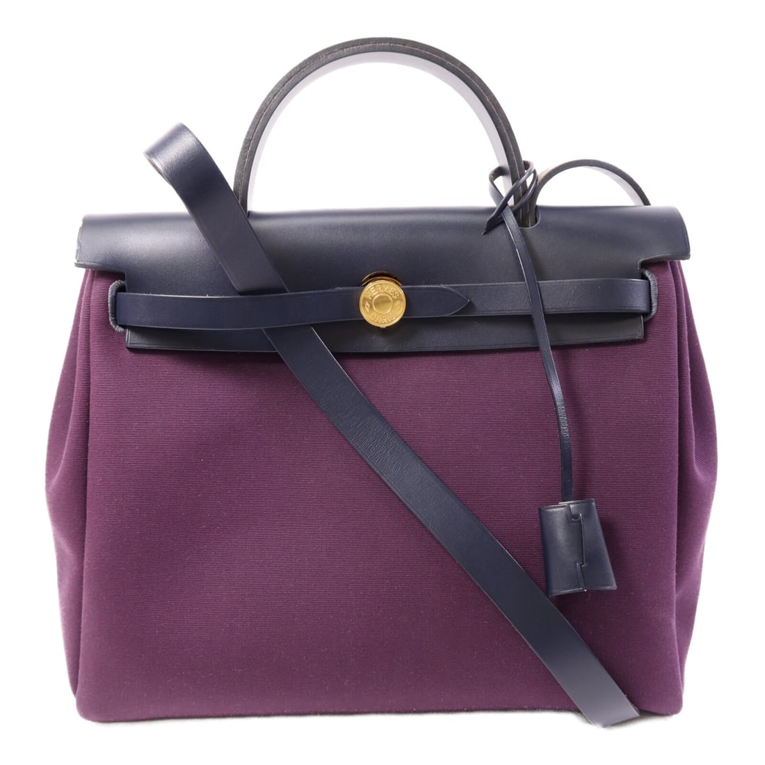 Herbag PM Purple Canvas Shoulder Bag with Gold Hardware by Hermes: Herbag PM Purple Canvas Shoulder Bag with Gold Hardware by Hermes This Hermes Herbag PM is a versatile two-way shoulder bag crafted from durable purple canvas. Made in France, it features a stylish de