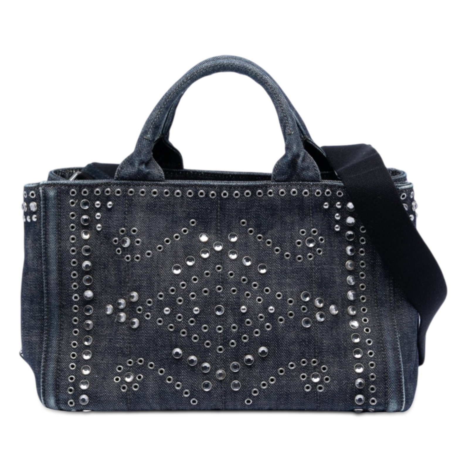 Prada Canapa Denim Tote with Stud Accents and Logo Detail: Prada Canapa Denim Tote with Stud Accents and Logo Detail This Prada Canapa tote bag features a studded denim exterior, rolled handles, and a detachable flat canvas strap. The open top design offers e