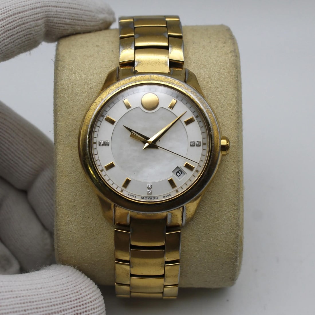 Bellina Mother of Pearl Dial Gold Tone Quartz Steel Watch by Movado: Bellina Mother of Pearl Dial Gold Tone Quartz Steel Watch by Movado This Movado Bellina wristwatch features a gold tone stainless steel bracelet and case with a mother-of-pearl dial. Powered by a quar
