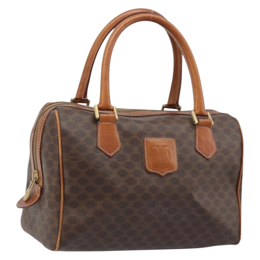 CELINE Macadam Brown PVC Canvas Handbag with Leather Trim Gold Accents: CELINE Macadam Brown PVC Canvas Handbag with Leather Trim Gold Accents This CELINE Macadam canvas hand bag features brown PVC leather with gold-tone accents. Designed for women, it showcases the signa