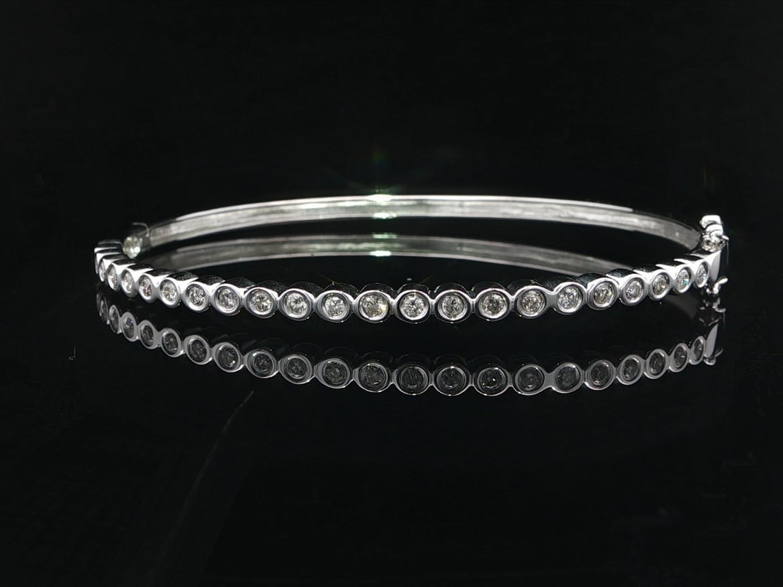0.50ctw Diamond Bezel Set 14k White Gold Hinged Bangle Bracelet 6.5 Inch: 0.50ctw Diamond Bezel Set 14k White Gold Hinged Bangle Bracelet 6.5 Inch This stackable hinged open bangle bracelet is crafted from solid 14k white gold and features 23 natural round brilliant cut dia