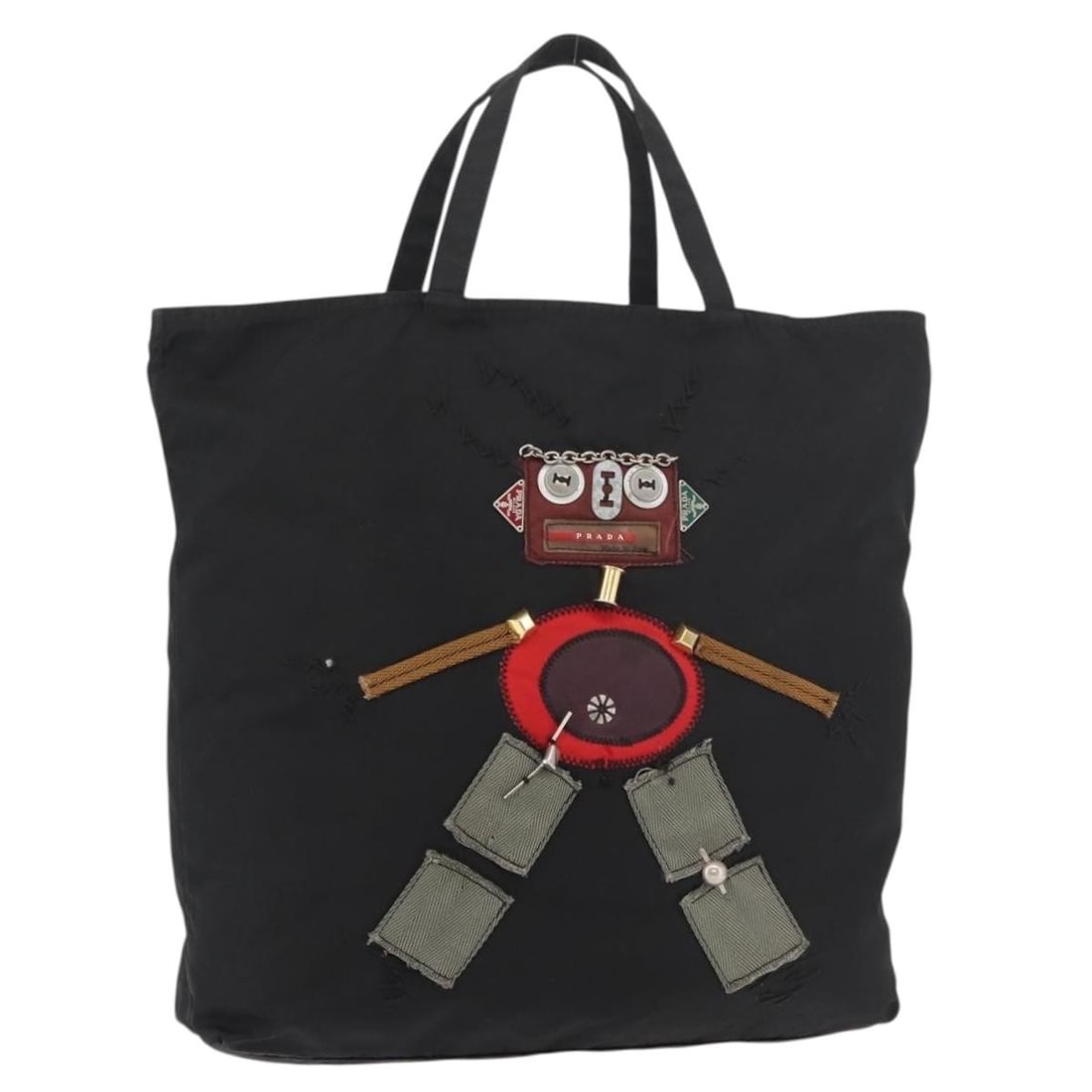 Prada black nylon tote with silver accents Italy: Prada black nylon tote with silver accents Italy This PRADA Robot tote bag is crafted from black nylon with silver accents. Designed for women, it features a spacious interior and a practical handle d