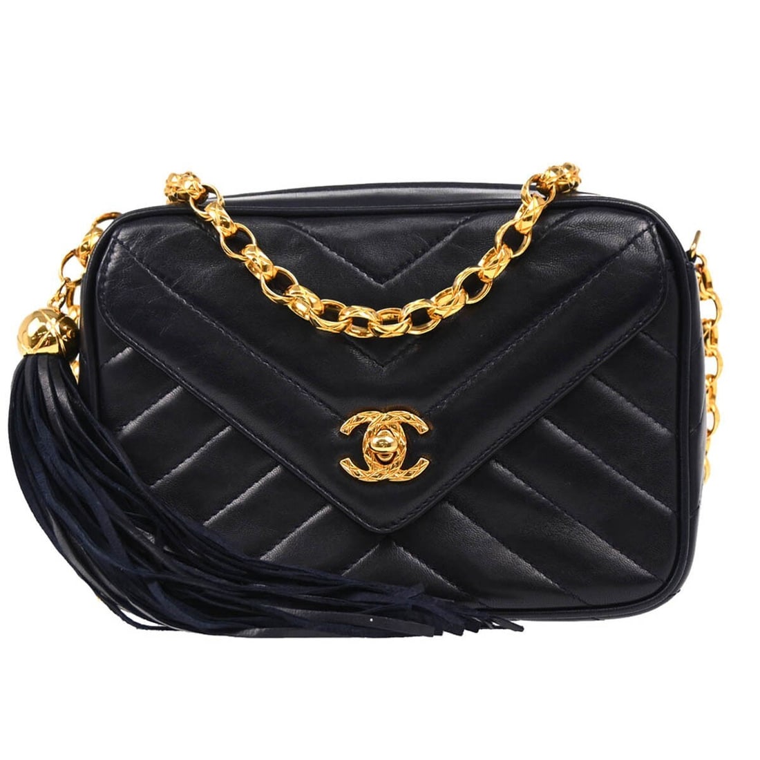 CHANEL Mini Navy Lambskin Fringe Crossbody Bag: CHANEL Mini Navy Lambskin Fringe Crossbody Bag This Chanel Mini Chevron Camera Bag is crafted from luxurious navy lambskin leather and features a chevron pattern. Designed in Italy, the bag is accente