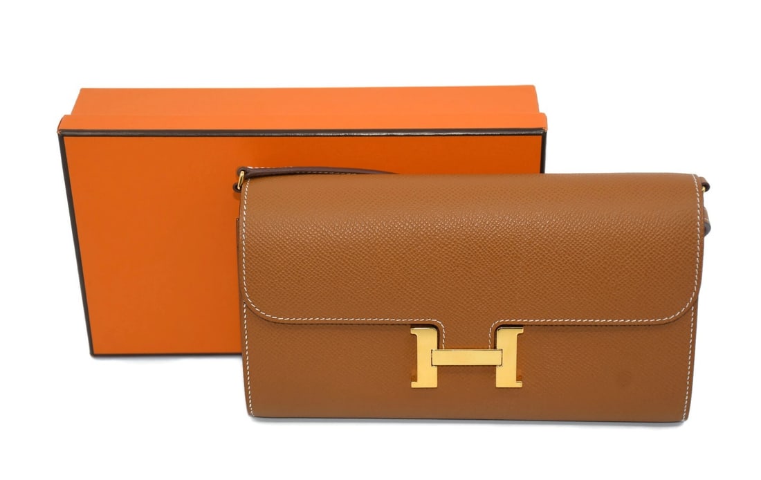 Hermes Constance Brown Leather Clutch: Hermes Constance Brown Leather Clutch This Hermes Constance clutch bag features a sophisticated brown leather exterior and a sleek, compact design. Crafted in France, this clutch is designed for women