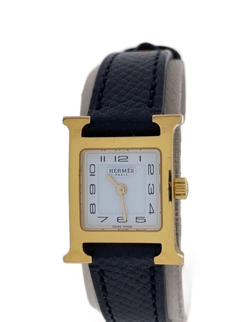 Hermes H Watch HH1.101 White Leather Wristwatch: Hermes H Watch HH1.101 White Leather Wristwatch This Hermes H Watch HH1.101 is a women's wristwatch crafted in Switzerland. It features a white leather band and a compact case, showing slight signs of