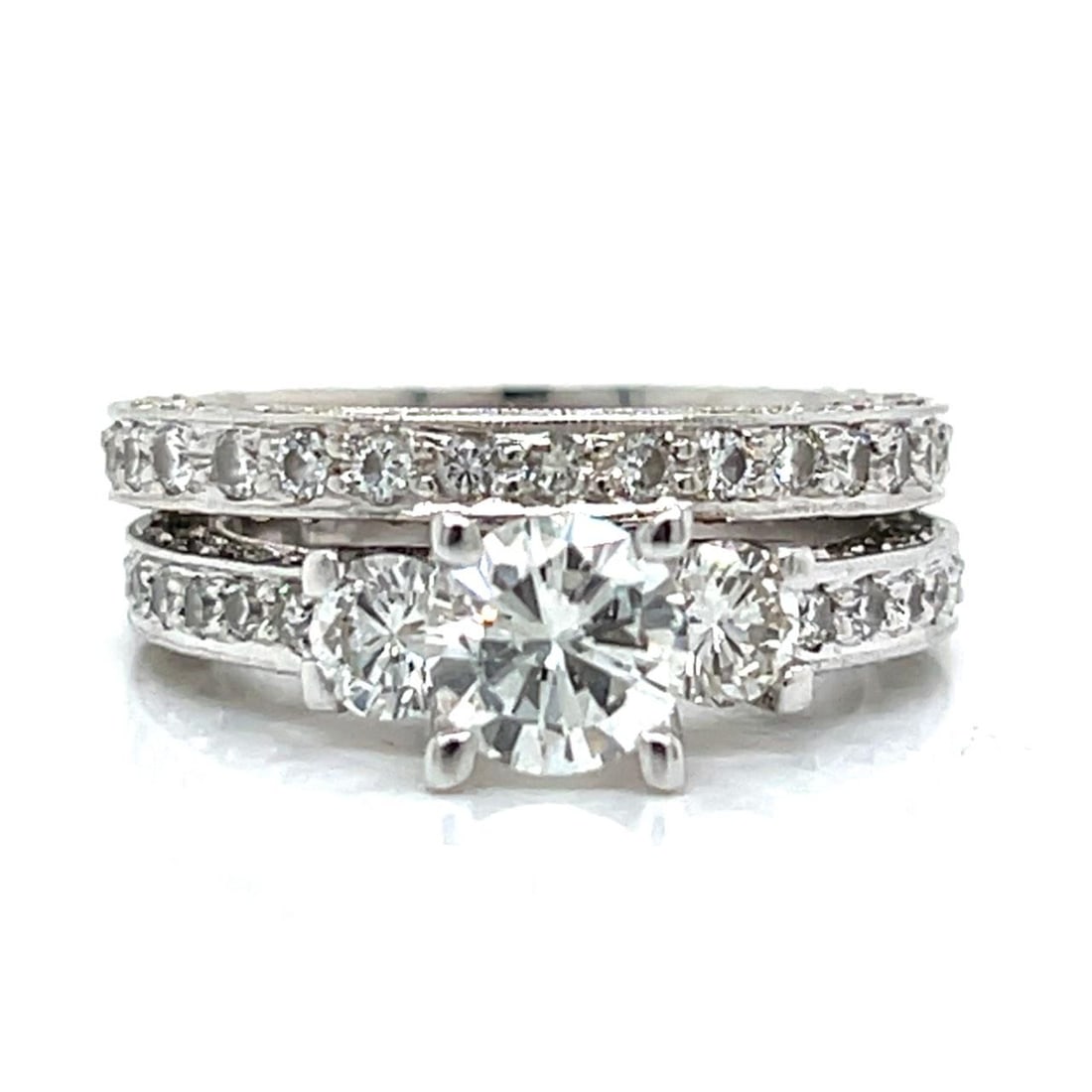 18K White Gold 1.00 Ct Diamond Ring and Eternity Band Set: 18K White Gold 1.00 Ct Diamond Ring and Eternity Band Set This exquisite set features an 18K white gold diamond ring accompanied by a matching diamond eternity band. The ring is adorned with a stunnin