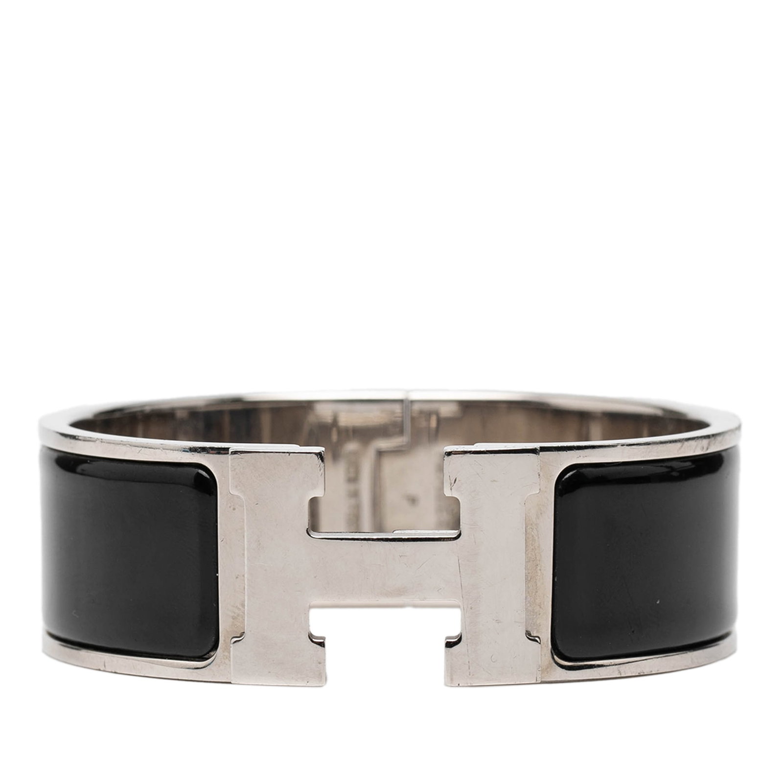 Hermes Clic Clac H PM Wide Enamel Bracelet with Palladium Plating: Hermes Clic Clac H PM Wide Enamel Bracelet with Palladium Plating This Hermes Wide Enamel Clic Clac H Bracelet PM features a black enamel finish on a palladium plated metal body and is secured by an H