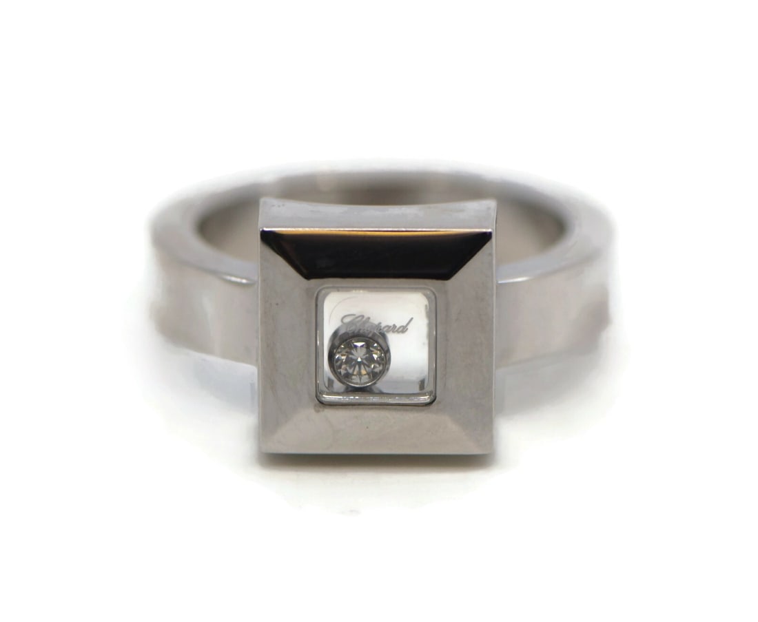 Chopard Happy Diamond 18K White Gold Size 5 Ring: Chopard Happy Diamond 18K White Gold Size 5 Ring This pre-owned Chopard Happy Diamond ring is crafted from 18K white gold and features a unique design with a transparent section showcasing a diamond. 