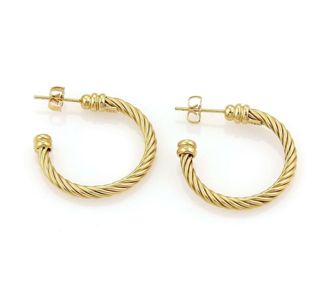 Charriol 18k Yellow Gold Twisted Wire Hoop Earrings: Charriol 18k Yellow Gold Twisted Wire Hoop Earrings These Charriol hoop earrings are crafted from 18k yellow gold and showcase the brand's signature twisted wire design. The earrings feature a sculptu