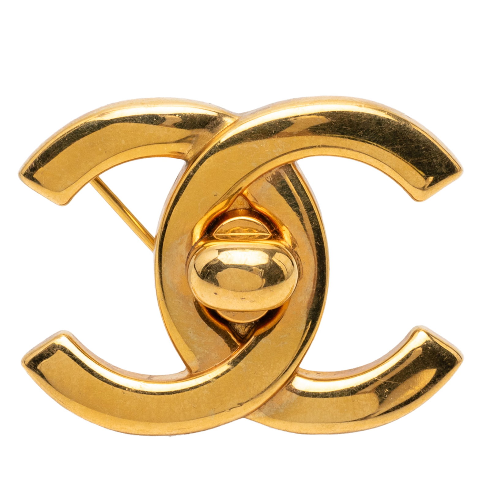 Chanel CC Gold Plated Metal Pin Brooch: Chanel CC Gold Plated Metal Pin Brooch This Chanel CC Gold Plated Turn Lock Brooch features a gold-plated metal body with a turn lock design and a back pin closure. The brooch is categorized as costum
