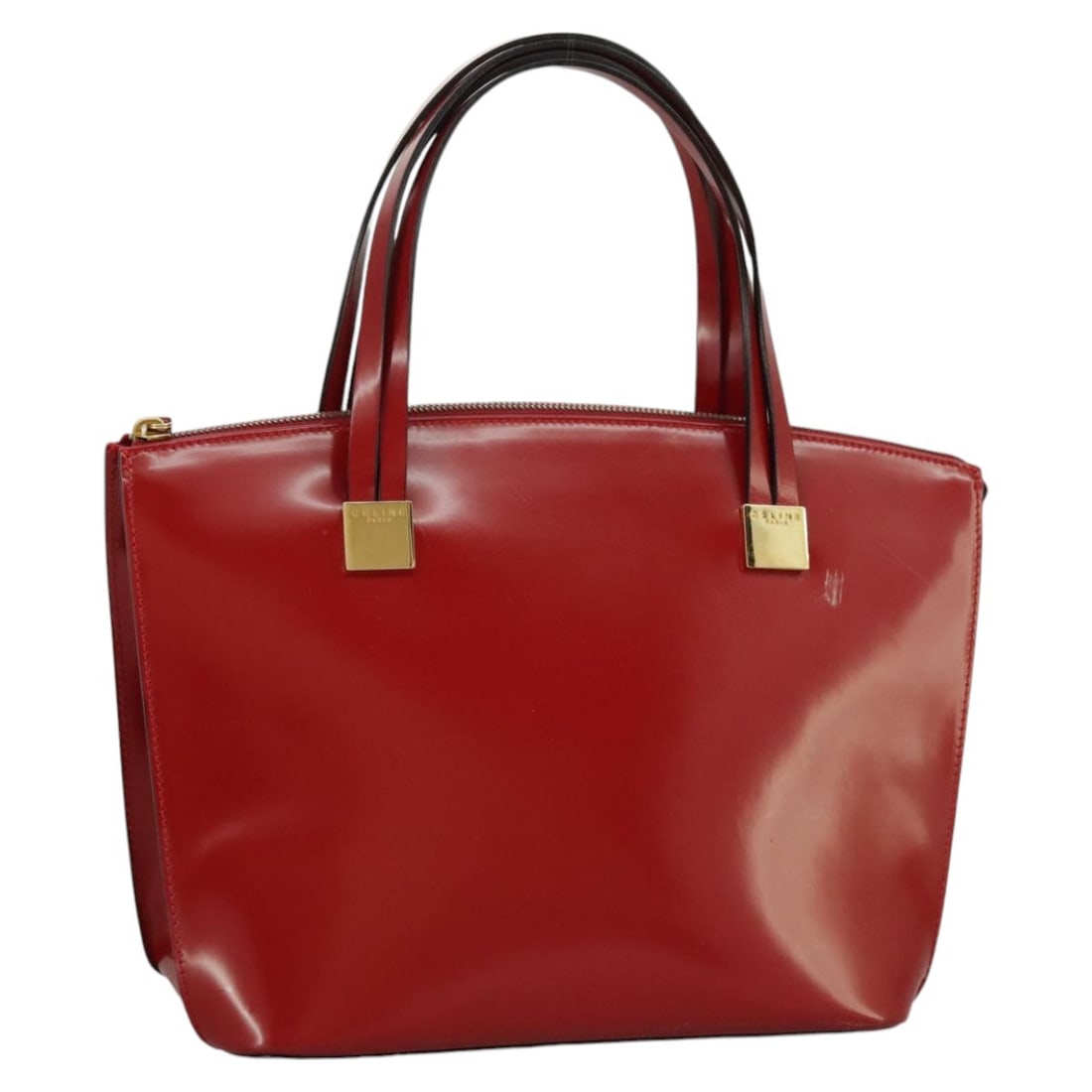 Celine Red Patent Leather Handbag with Gold Accents for Women: Celine Red Patent Leather Handbag with Gold Accents for Women This Celine women's handbag is crafted from patent leather in a striking red and gold color combination. Made in Italy, it features a stru