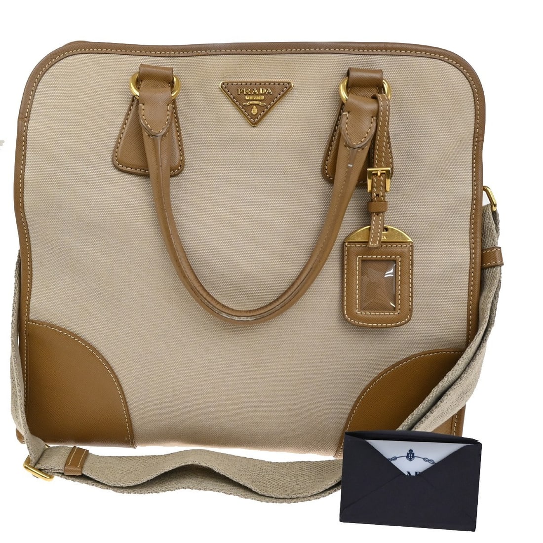 Prada Convertible Tote Beige Canvas with Saffiano Leather Trim: Prada Convertible Tote Beige Canvas with Saffiano Leather Trim This Prada Convertible Tote is crafted from beige canvas with Saffiano leather accents, designed for women. The bag features a spacious i