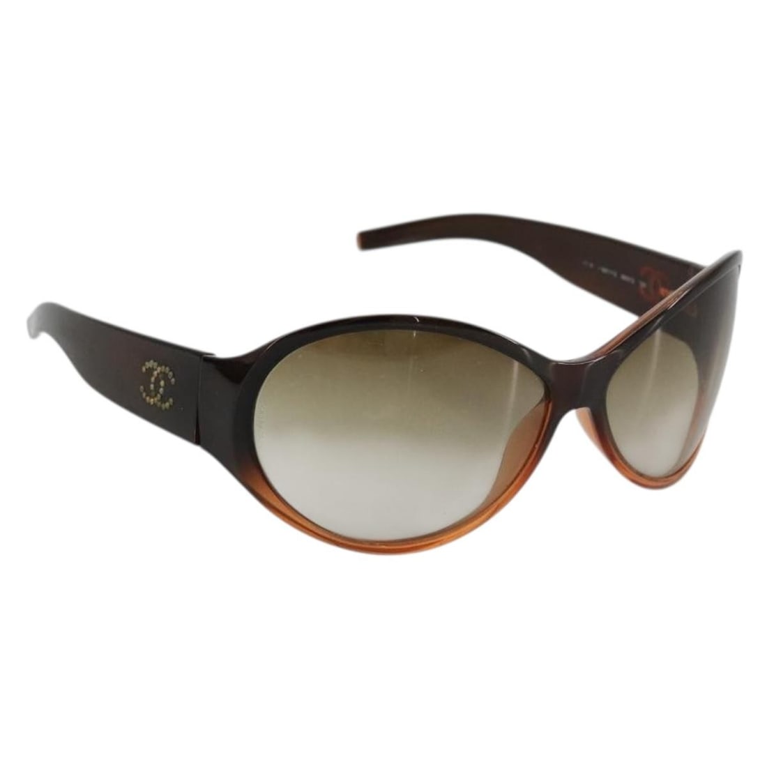 CHANEL Brown Plastic Sunglasses With Case: CHANEL Brown Plastic Sunglasses With Case These CHANEL sunglasses feature a brown plastic frame and are designed for women. Made in Italy, they come with a sunglass case. The sunglasses show significa