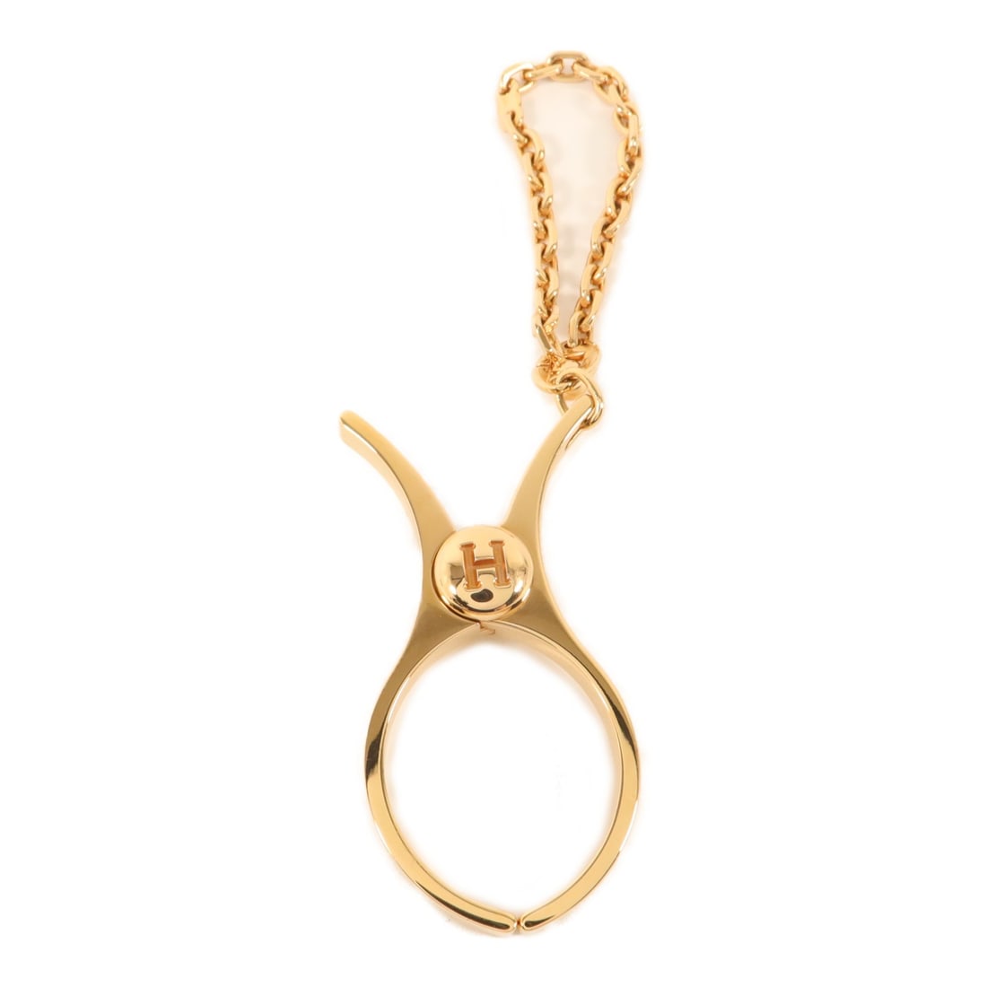 Hermes Filou glove clip charm pink gold tone metal: Hermes Filou glove clip charm pink gold tone metal This Hermes Filou Glove Clip is a stylish accessory designed as a charm. Crafted from gold-tone metal with a pink hue, it adds a touch of elegance to
