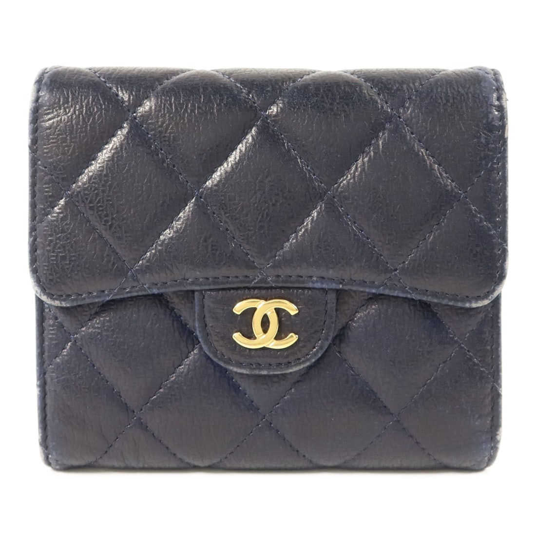 Chanel Navy Blue Calfskin Trifold Wallet with Gold Tone CC Logo: Chanel Navy Blue Calfskin Trifold Wallet with Gold Tone CC Logo This CHANEL tri-fold wallet is crafted from navy blue calfskin leather and features the iconic CC logo with gold tone hardware. Designed
