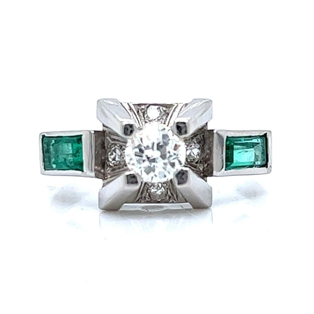 Art Deco Platinum Ring with Diamond and Emeralds: Art Deco Platinum Ring with Diamond and Emeralds This exquisite Art Deco ring features a stunning design crafted in platinum. The centerpiece showcases an approximately 0.55 carat diamond, elegantly f