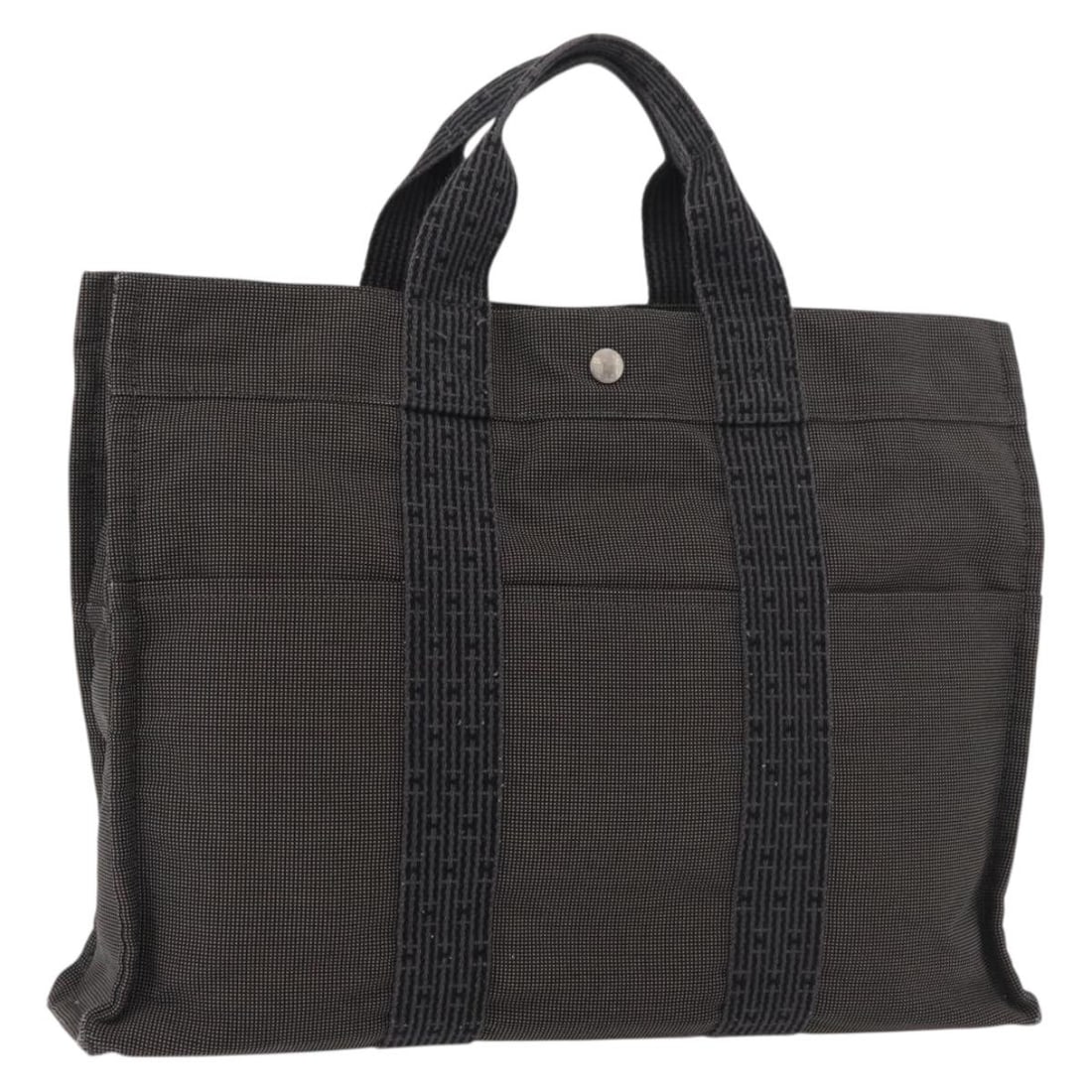Gray Canvas Fourre-tout Herline Tote Bag by Hermes: Gray Canvas Fourre-tout Herline Tote Bag by Hermes This is a Hermes Fourre-tout Herline bag crafted from gray canvas. Designed for women, it features a spacious interior and sturdy handles. The bag sh