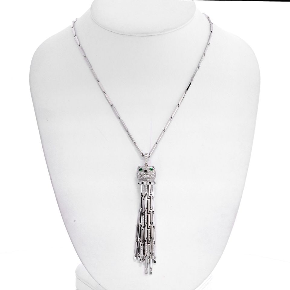 Cartier 18K White Gold Panthere Tassel Necklace with Diamonds and Emeralds: Cartier 18K White Gold Panthere Tassel Necklace with Diamonds and Emeralds This exquisite Cartier necklace features an 18K white gold Panthere tassel pendant, showcasing a luxurious blend of materials