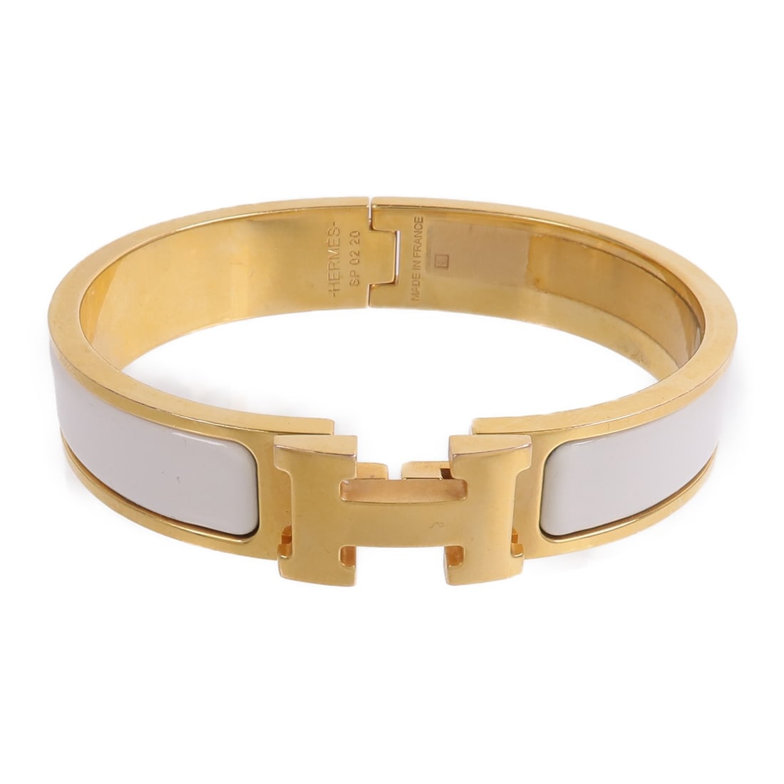 Hermes Clic H white enamel bangle gold tone: Hermes Clic H white enamel bangle gold tone This Hermes Clic H bangle features a white enamel finish with gold-tone accents, offering a chic and timeless accessory for women. Crafted in France, the br