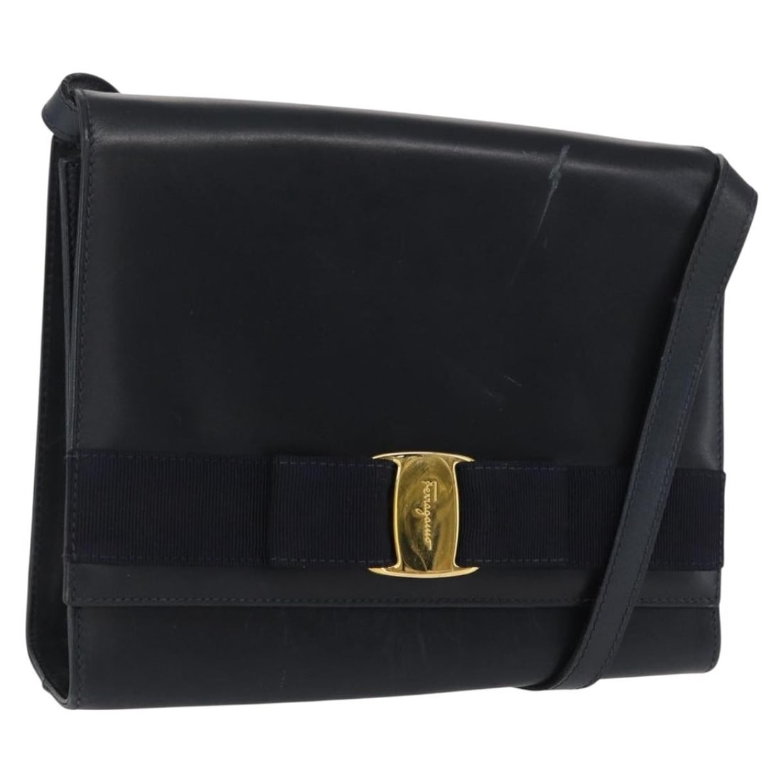 Navy Leather Salvatore Ferragamo Vala Shoulder Bag with Gold Tone Accents: Navy Leather Salvatore Ferragamo Vala Shoulder Bag with Gold Tone Accents This Salvatore Ferragamo Vala shoulder bag is crafted from navy leather with gold-tone accents. Made in Italy, it features an 
