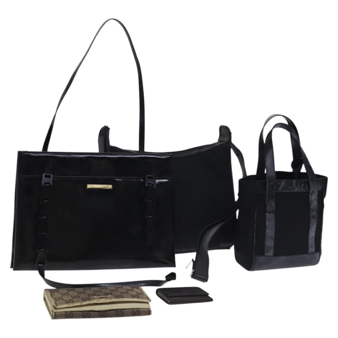 Gucci Black GG Canvas Patent Leather Shoulder Bag: Gucci Black GG Canvas Patent Leather Shoulder Bag This Gucci GG Canvas and patent leather shoulder bag set features a black exterior with signature GG canvas and patent leather accents. Designed for w