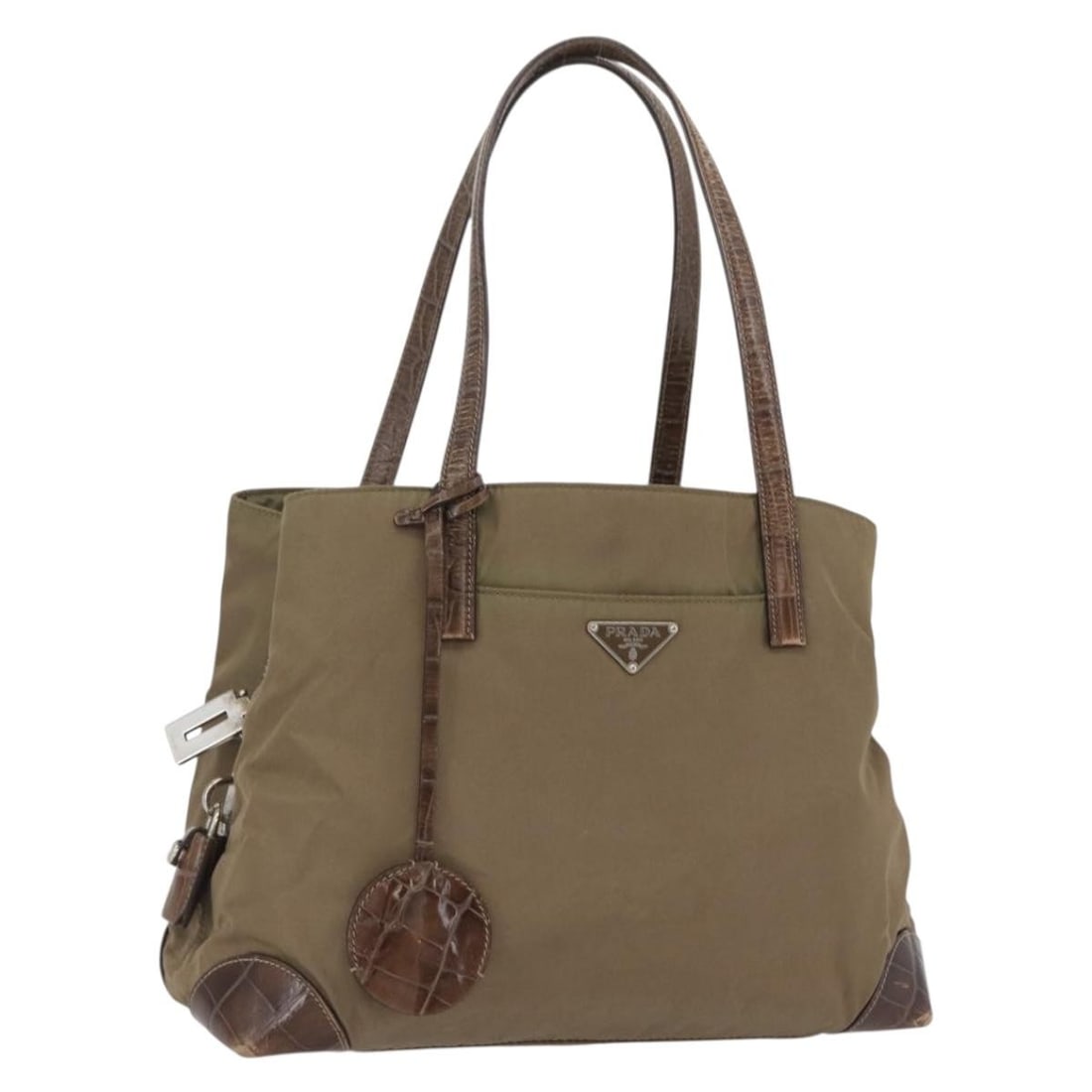 PRADA Nylon Khaki Silver Hand Bag with Padlock and Keys: PRADA Nylon Khaki Silver Hand Bag with Padlock and Keys This PRADA handbag is crafted from durable nylon in a khaki and silver color scheme. Designed for women, it features a spacious interior and pra