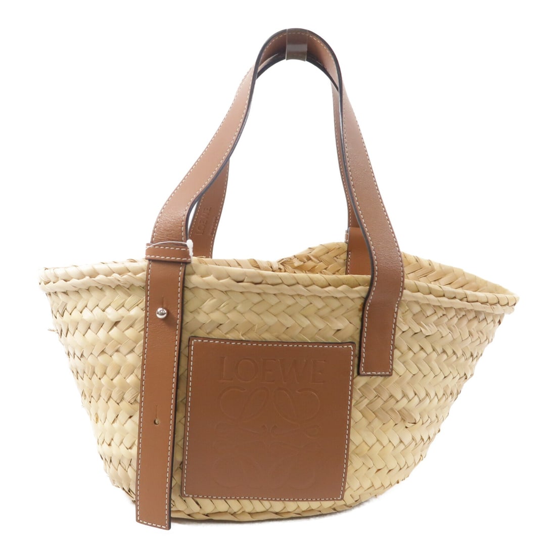 LOEWE Brown Calfskin Raffia Tote Bag: LOEWE Brown Calfskin Raffia Tote Bag This LOEWE basket tote bag is crafted from a combination of calfskin leather and raffia in a brown color. Designed for women, it features a classic tote silhouette