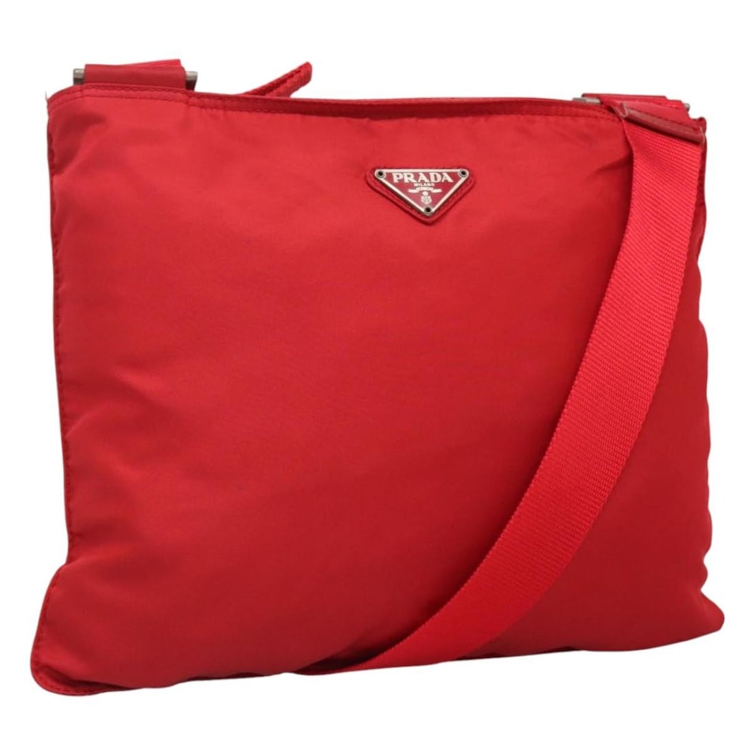 Prada red nylon shoulder bag Italy 12.2 x 9.8 inch: Prada red nylon shoulder bag Italy 12.2 x 9.8 inch This PRADA shoulder bag is crafted from durable nylon in a striking red and silver color combination. Designed for women, it features an adjustable s