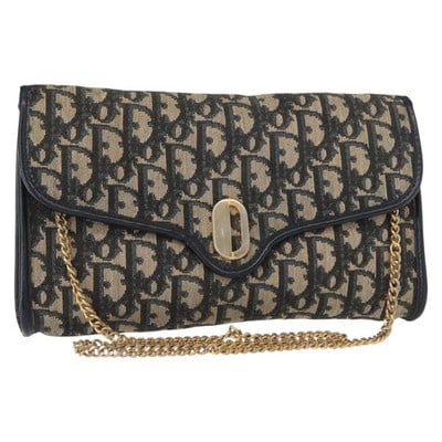 Christian Dior Trotter Canvas Navy Gold Shoulder Bag: Christian Dior Trotter Canvas Navy Gold Shoulder Bag This Christian Dior shoulder bag features the iconic Trotter canvas in a navy and gold color scheme. Designed with a chain shoulder strap, the bag 