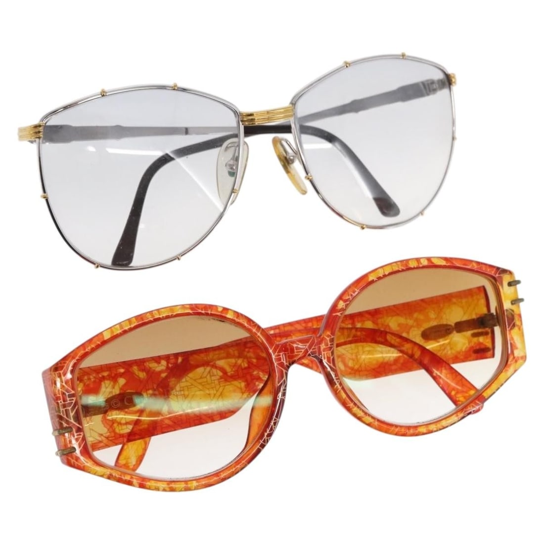 Set of 2 Christian Dior Brown Silver Plastic Sunglasses: Set of 2 Christian Dior Brown Silver Plastic Sunglasses This set includes two pairs of Christian Dior sunglasses crafted from plastic in brown and silver tones. Made in Italy, these sunglasses show si