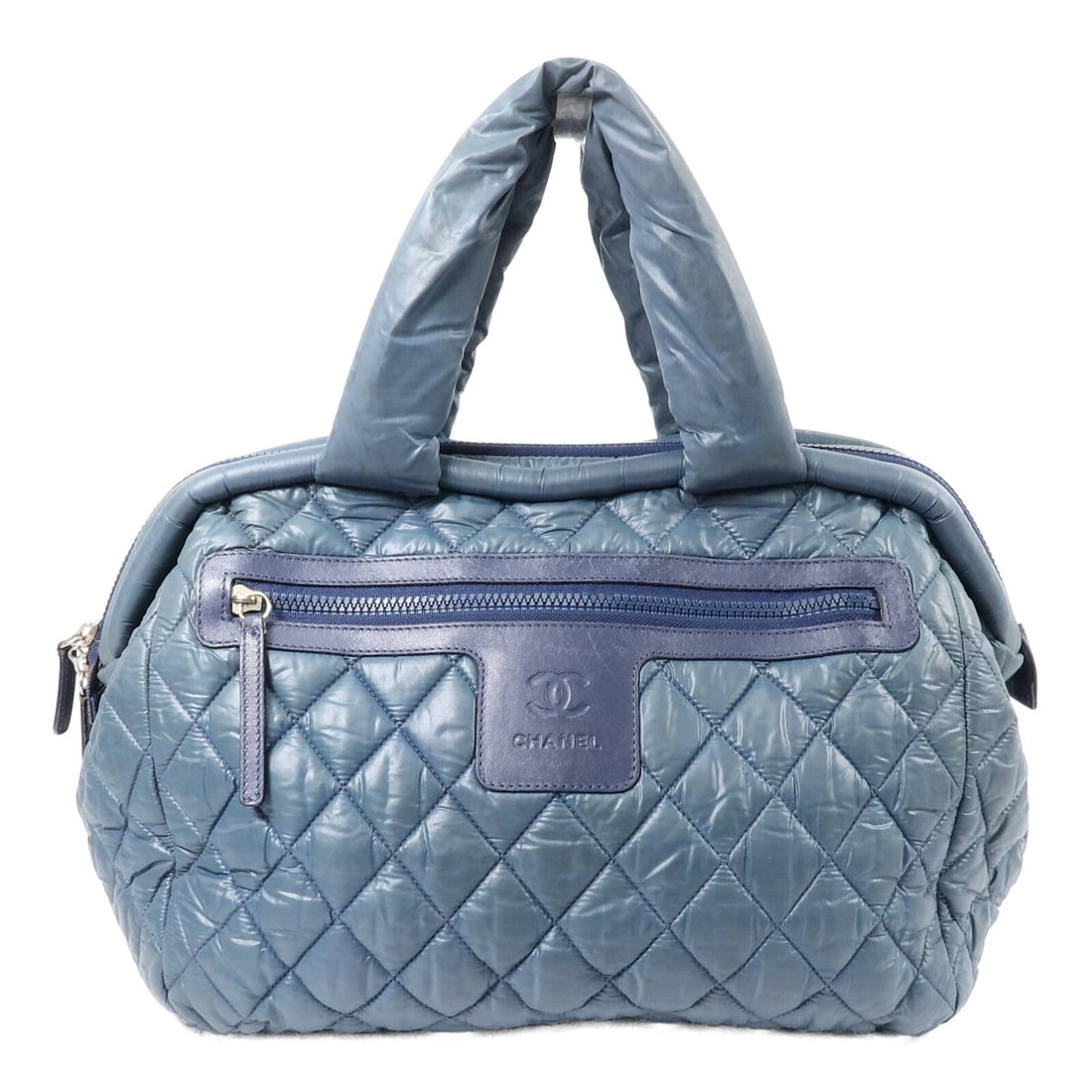 Blue Nylon CHANEL Coco Cocoon Handbag CC SHW: Blue Nylon CHANEL Coco Cocoon Handbag CC SHW This CHANEL Coco Cocoon handbag features a classic CC design with silver-tone hardware. Crafted from blue nylon, it offers a spacious interior suitable for