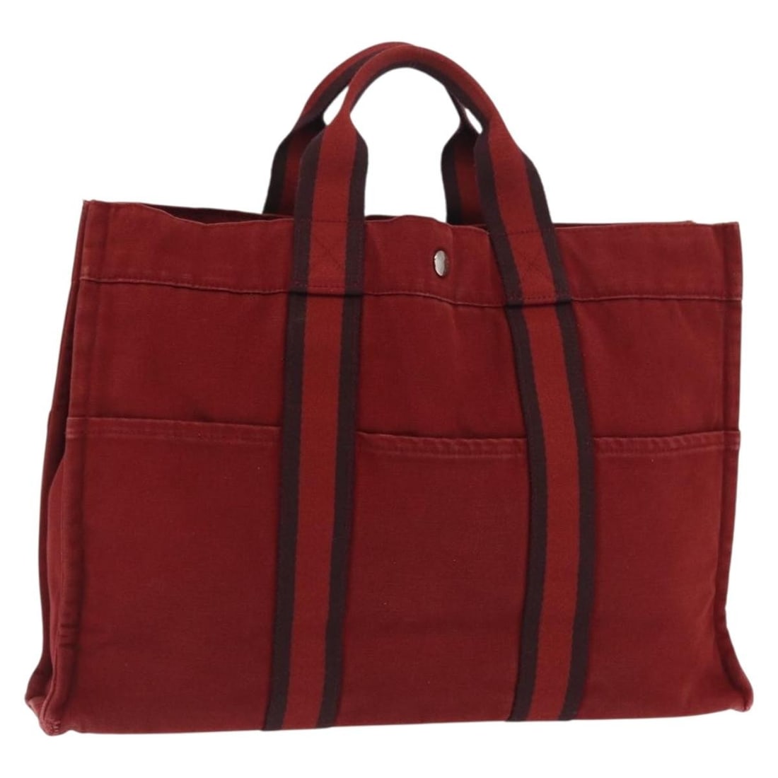 Deauville Red Canvas Handbag by Hermes with Silver Accents: Deauville Red Canvas Handbag by Hermes with Silver Accents This is a Hermes Deauville hand bag crafted from canvas in a red and silver color combination. The bag features a spacious interior and is de