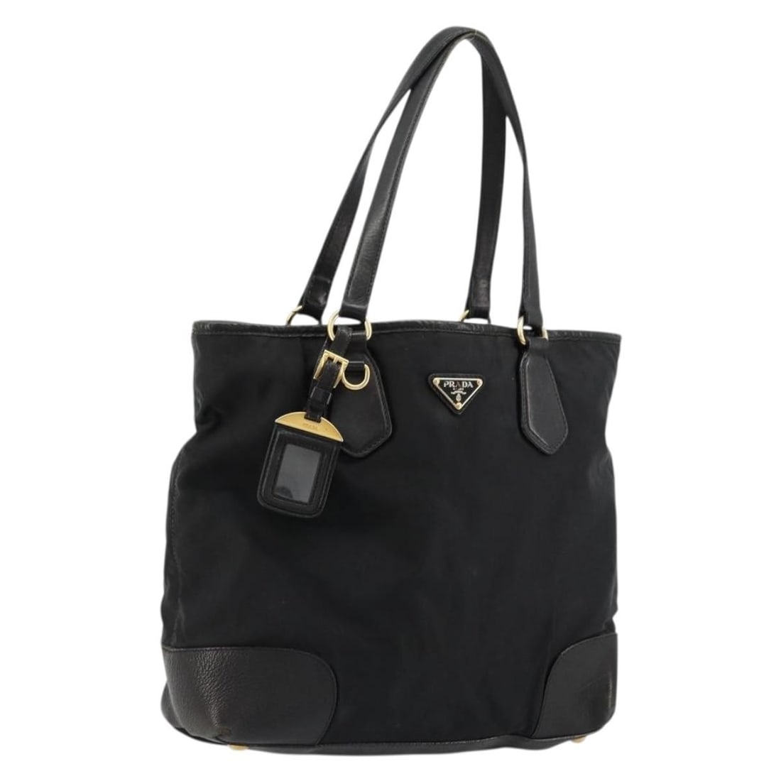 Prada black nylon tote with gold accents and name tag: Prada black nylon tote with gold accents and name tag This PRADA tote bag features a black nylon exterior with gold-tone accents and leather trim. Designed for women, it offers a spacious interior and