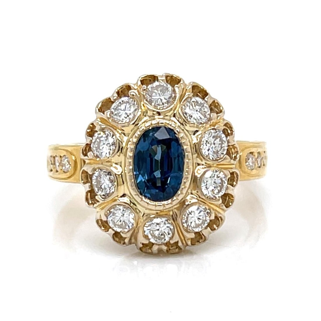 Sapphire and Diamond Ring in 18K Yellow Gold Size 8.5: Sapphire and Diamond Ring in 18K Yellow Gold Size 8.5 This 18K yellow gold ring features a central sapphire of approximately 0.60 carats, complemented by sixteen diamonds totaling approximately 1.20 c