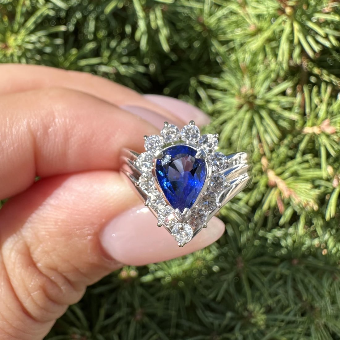 Platinum 2.06ctw Pear Royal Blue Sapphire Diamond Halo Ring: Platinum 2.06ctw Pear Royal Blue Sapphire Diamond Halo Ring This exquisite cocktail ring features a stunning natural pear-shaped royal blue sapphire, measuring 8.6x5.7mm and weighing 1.41ct. The sapph