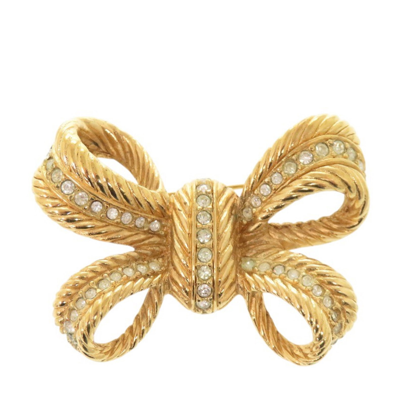 Dior strass bow brooch gold plated metal: Dior strass bow brooch gold plated metal This Dior brooch features a gold plated metal construction with strass embellishments, designed in an elegant bow motif. It is equipped with a back pin closure