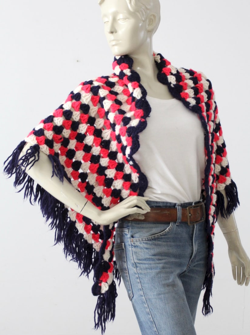 1970s Hand-Knit Shawl by Phyllis Red White Navy Fringe: 1970s Hand-Knit Shawl by Phyllis Red White Navy Fringe Celebrate the vibrant spirit of the 1970s with this vintage hand-knit shawl, featuring a striking combination of red, white, and navy blue tones.