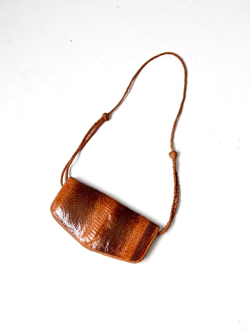 1970s Vintage Snakeskin Leather Envelope Shoulder Bag: 1970s Vintage Snakeskin Leather Envelope Shoulder Bag This vintage 1970s snakeskin leather shoulder bag features an elegant envelope style with a long braided leather strap, allowing for versatile wea